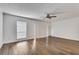 Bright living room with light hardwood floors, a ceiling fan, and large windows with blinds at 6851 Roswell Rd # A21, Sandy Springs, GA 30328