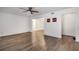 An open-concept living room featuring wood flooring, a ceiling fan, and a view into other living areas at 6851 Roswell Rd # A21, Sandy Springs, GA 30328