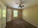 Neutral bedroom with carpet, a ceiling fan, a window, and a door for easy access at 6893 Spring Valley Ct, Douglasville, GA 30135