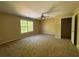 This bedroom features carpet, a ceiling fan, a window, and a closet for easy storage at 6893 Spring Valley Ct, Douglasville, GA 30135