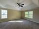 Primary bedroom featuring carpet floors, large windows and trey ceiling with ceiling fan at 6893 Spring Valley Ct, Douglasville, GA 30135