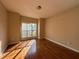 Empty bedroom with hardwood floors, a large window, and neutral wall color at 6893 Spring Valley Ct, Douglasville, GA 30135