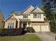 Charming two-story home with brick accents, manicured lawn, and attached two car garage at 6893 Spring Valley Ct, Douglasville, GA 30135