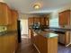 Well-lit kitchen featuring an island, stainless steel appliances, and wooden cabinets at 6893 Spring Valley Ct, Douglasville, GA 30135