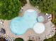 Aerial shot of a clover-shaped swimming pool and sun loungers at 1261 Ashford Creek Ne Park, Brookhaven, GA 30319