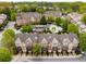 Aerial of townhomes with balconies and lush landscaping and a community pool at 1261 Ashford Creek Ne Park, Brookhaven, GA 30319