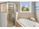 Bright bathroom featuring a separate shower, a soaking tub, and tile surround at 1261 Ashford Creek Ne Park, Brookhaven, GA 30319