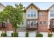 Charming townhome with three garage doors, a private balcony, brick and siding, and a manicured lawn at 1261 Ashford Creek Ne Park, Brookhaven, GA 30319