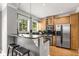 Modern kitchen with stainless steel appliances, granite countertops, and breakfast bar seating at 1261 Ashford Creek Ne Park, Brookhaven, GA 30319