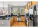 Well-lit kitchen with stainless steel appliances, granite countertops, and wood cabinetry at 1261 Ashford Creek Ne Park, Brookhaven, GA 30319