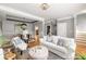 Bright living room with hardwood floors, white sofa, and adjacent dining area at 1261 Ashford Creek Ne Park, Brookhaven, GA 30319