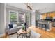 Open living room featuring hardwood floors, a ceiling fan, and a view through large windows at 1261 Ashford Creek Ne Park, Brookhaven, GA 30319