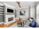 Cozy living room with a fireplace, built-in shelving, and a comfortable seating area at 1261 Ashford Creek Ne Park, Brookhaven, GA 30319
