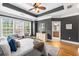 Tranquil main bedroom featuring a tray ceiling, light furnishings, and large windows at 1261 Ashford Creek Ne Park, Brookhaven, GA 30319