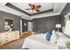 Relaxing main bedroom with dark walls, a tray ceiling, and stylish furnishings at 1261 Ashford Creek Ne Park, Brookhaven, GA 30319