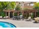 Relaxing poolside lounge area with seating and a barbecue under a pergola at 1261 Ashford Creek Ne Park, Brookhaven, GA 30319