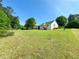 Expansive backyard with lush green lawn and a cozy deck, ideal for relaxation and play at 1412 Brighton Pl, Loganville, GA 30052