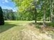 Beautiful backyard with a sitting area amid mature trees, perfect for enjoying nature at 1412 Brighton Pl, Loganville, GA 30052