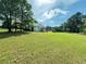 Large, grassy backyard with mature trees offers plenty of space for outdoor activities at 1412 Brighton Pl, Loganville, GA 30052