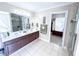 Well-lit bathroom showcasing a double vanity, shower, and walk-in closet at 1412 Brighton Pl, Loganville, GA 30052