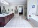 Bright bathroom featuring double vanity, walk-in shower, and soaking tub at 1412 Brighton Pl, Loganville, GA 30052