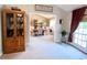Open dining room with a decorative cabinet, light colored walls, and natural light shining through the door at 1412 Brighton Pl, Loganville, GA 30052