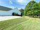 Exterior view of a home with a well-maintained lawn, garage, and lush trees at 1412 Brighton Pl, Loganville, GA 30052