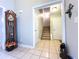 Spacious foyer with tile flooring, view of staircase, and a decorative grandfather clock at 1412 Brighton Pl, Loganville, GA 30052