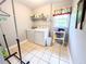 Functional laundry room with washer, dryer, and storage shelves at 1412 Brighton Pl, Loganville, GA 30052
