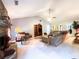 Spacious living room featuring a stone fireplace, plush carpet, and a ceiling fan for added comfort at 1412 Brighton Pl, Loganville, GA 30052