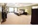 Main bedroom features large windows, ample natural light, and neutral carpet at 1412 Brighton Pl, Loganville, GA 30052