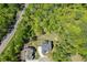 Aerial shot of a home surrounded by a mature tree canopy with a spacious lot outlined in yellow at 4208 Sierra Creek Ct, Hoschton, GA 30548