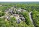 An aerial view of a property nestled among lush trees in a well-developed neighborhood at 4208 Sierra Creek Ct, Hoschton, GA 30548