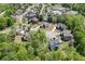 Aerial view of a home nestled among lush green trees in a residential neighborhood at 4208 Sierra Creek Ct, Hoschton, GA 30548