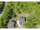 Aerial view showcases the home surrounded by lush trees providing a sense of privacy and seclusion at 4208 Sierra Creek Ct, Hoschton, GA 30548