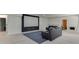 Large finished basement space with concrete floors and a projection screen setup, ideal for entertaining or media enjoyment at 4208 Sierra Creek Ct, Hoschton, GA 30548