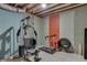 A basement features an exercise machine, treadmill, and tires for a home gym setup at 4208 Sierra Creek Ct, Hoschton, GA 30548