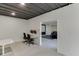 Open basement layout with designated spaces for work and media, featuring concrete flooring and ample lighting at 4208 Sierra Creek Ct, Hoschton, GA 30548