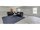 Spacious finished basement living area with two sofas, a coffee table, and good lighting perfect for relaxing at 4208 Sierra Creek Ct, Hoschton, GA 30548