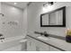 Bathroom featuring a white vanity, large mirror, and a tiled shower and tub at 4208 Sierra Creek Ct, Hoschton, GA 30548