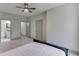 A light-filled bedroom with ensuite bathroom and a grey carpeted floor at 4208 Sierra Creek Ct, Hoschton, GA 30548