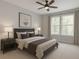 Comfortable bedroom with a queen bed, two windows, ceiling fan, and warm neutral colors at 4208 Sierra Creek Ct, Hoschton, GA 30548