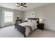 Comfortable bedroom featuring a bed with black frame, soft lighting, and a window at 4208 Sierra Creek Ct, Hoschton, GA 30548
