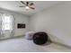 Relaxing bedroom area with cozy beanbag chairs, TV, and a large window at 4208 Sierra Creek Ct, Hoschton, GA 30548