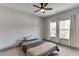 This bedroom offers natural light from two windows and has grey baseboards at 4208 Sierra Creek Ct, Hoschton, GA 30548