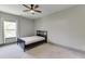 A cozy bedroom features neutral walls, carpet, and a ceiling fan at 4208 Sierra Creek Ct, Hoschton, GA 30548