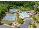 Aerial shot of community amenities including a swimming pool, tennis courts, playground and parking area at 4208 Sierra Creek Ct, Hoschton, GA 30548