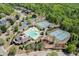 Aerial view of the neighborhood amenities showcasing a large pool, tennis courts, and lush landscaping at 4208 Sierra Creek Ct, Hoschton, GA 30548
