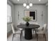 Contemporary dining room with a round table, modern lighting, and stylish decor at 4208 Sierra Creek Ct, Hoschton, GA 30548