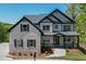 Beautiful front exterior showcasing brick and siding, manicured landscaping, and a welcoming porch at 4208 Sierra Creek Ct, Hoschton, GA 30548